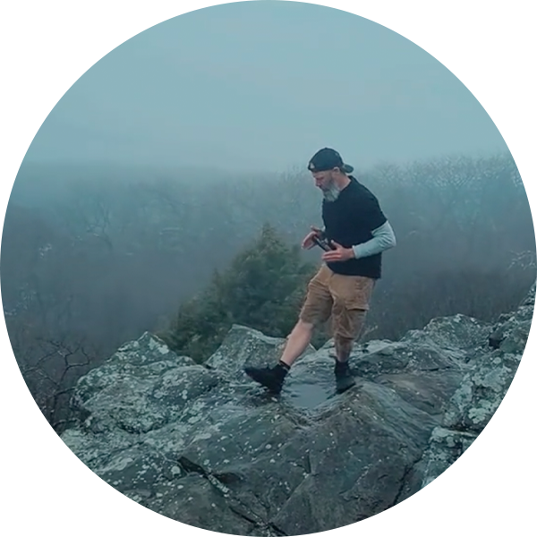 Steve doing a calf stretch while stand on rocks